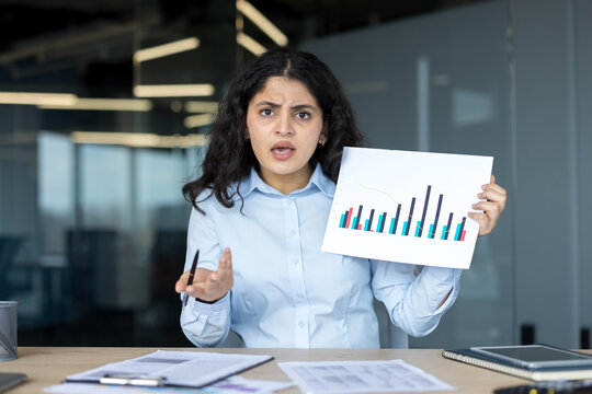 Frustrated businesswoman presenting financial report showing poor results