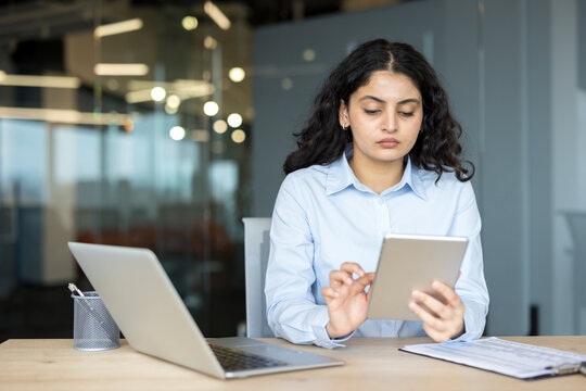 Young businesswoman using digital tablet in modern office