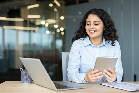 Professional woman using digital tablet smiling in office
