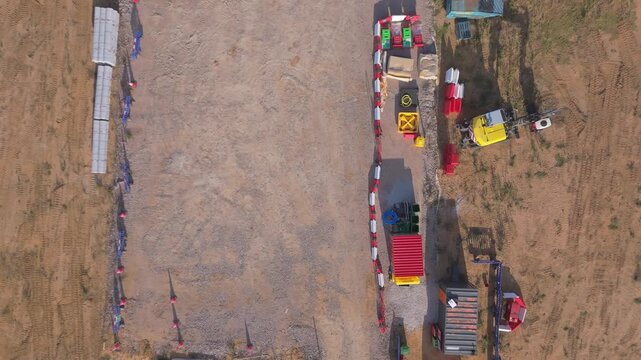 A top down rising drone view of the site compound construction area for underground wind farm cables, Norfolk, England