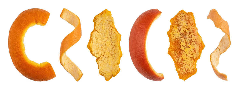 Collection of fresh orange citrus peels in various shapes and sizes, including spirals and curls, showcasing the textured zest and inner pith of the organic fruit