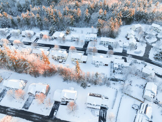 Obraz premium aerial view of residential community after snow storm under dusk sunlight
