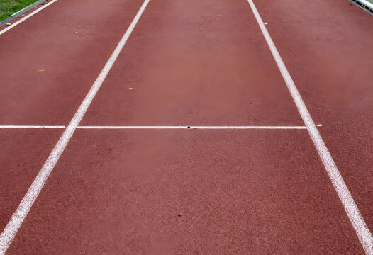 Athletic performance and competition, running track lanes with white markings for sports training and fitness goals on a professional stadium surface