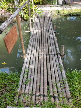 Traditional Rustic Bamboo Bridge Over Canal Water