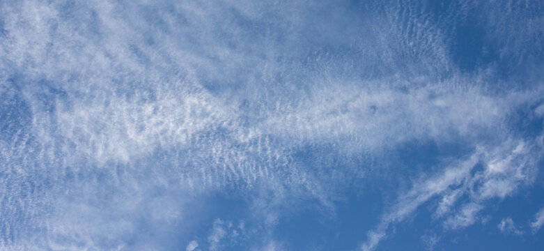 Blue sky with wispy cirrus clouds texture background