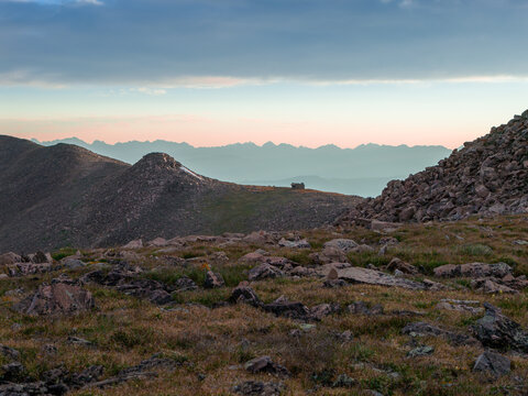 Aerial view of the rugged alpine landscape of Notch Mountain Shelter Sawatch Range Mount of the Holy Cross, featuring rocky slopes, tundra vegetation, and distant peaks in Vail, Colorado, USA.