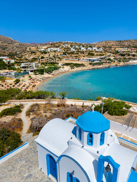 View of sea bay with beautiful beach and traditional church on Karpathos island in Ammopi village, Greece
