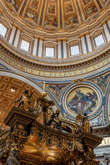 Rome, Italy - March 30, 2026 - Angels with crown and cross on top of the baldachin inside Saint Peters Basilica Rome © imagoDens