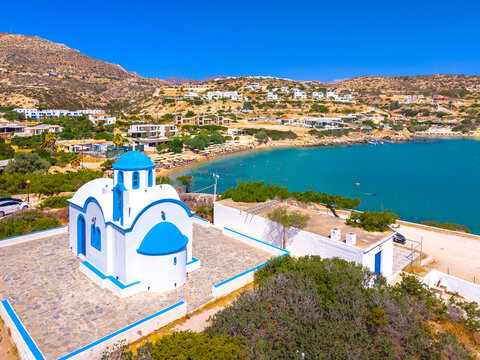 View of sea bay with beautiful beach and traditional church on Karpathos island in Ammopi village, Greece