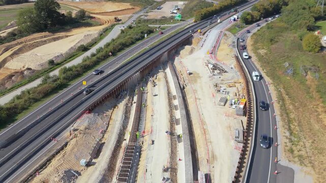 A rising drone view of the construction of the installation of an underpass from the A11 to A47 to enable free flowing traffic