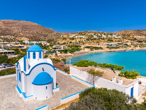 View of sea bay with beautiful beach and traditional church on Karpathos island in Ammopi village, Greece