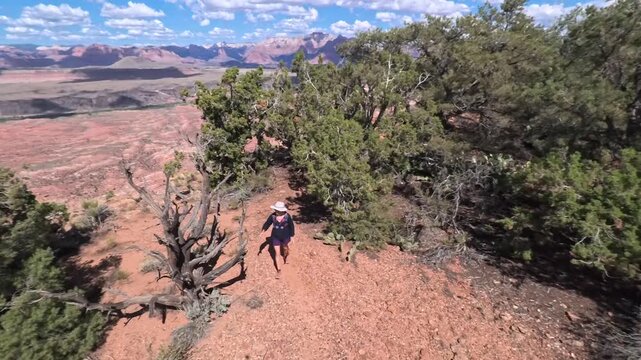 Experience the beauty of a senior woman hiking the Gander Trail, surrounded by breathtaking views in Utahs Dixie National Forest.