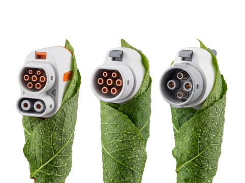 Electric vehicle charging plug green leaf wrapped in wet foliage with water drops on black background, representing sustainable clean energy transport and eco friendly electric mobility power system.