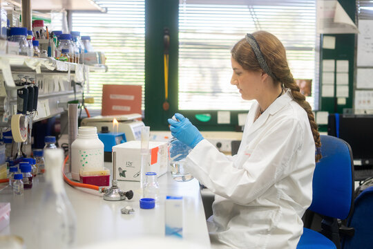Female scientist working with water beaker