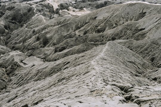 Hostile volcanic landscape, gaps and cracks, dry ground on volcano crater, Mount Bromo, Bromo Tengger Semeru National Park, Java, Indonesia
