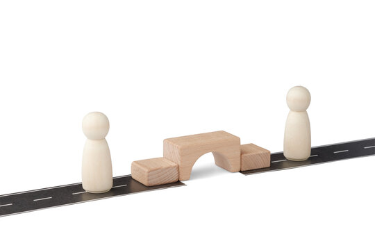 Partnership and connection concept with wooden bridge over road gap.