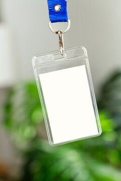Clear plastic badge holder with blue lanyard hanging
