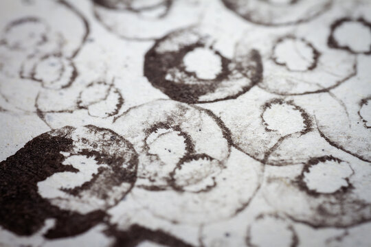 Extreme close up of black acrylic paint texture on paper. Selective focus.