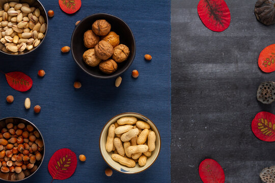 Food themed still life with crockery, various nuts and tea. Flat lay. Top view.