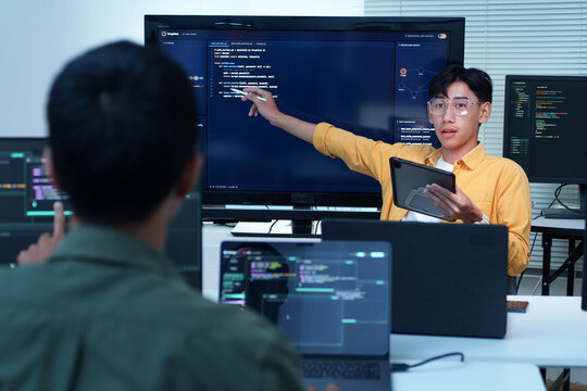 Software Engineer Presenting Code to Development Team