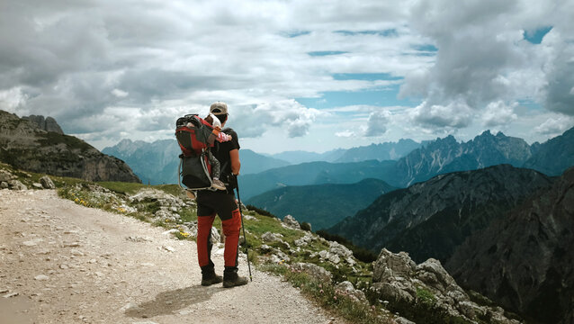 Father Hiking with Child Carrier Backpack on Mountain Trail