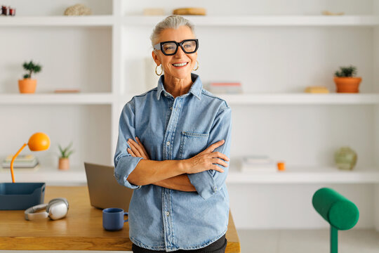 Mature woman with gray hair smiling in modern office