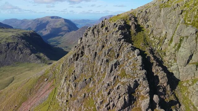 Aerial panoramic view of the Kirk Fell summit from the Great Cable Pike. Scenic Drone POV Exploration of the Lake District National Park, Cumbria, UK.