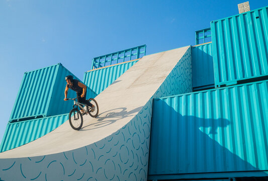 MTB Extreme Bicycle Rider on Shipping Containers Ramp