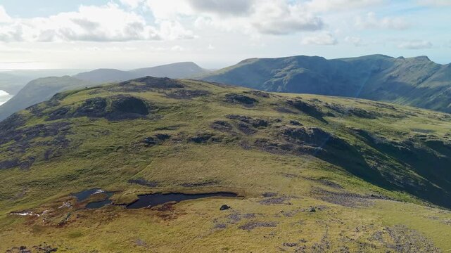 Aerial panoramic view of the Kirk Fell summit from the Great Cable Pike. Scenic Drone POV Exploration of the Lake District National Park, Cumbria, UK.