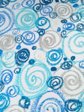 A continuous background pattern of blue, light blue, and silver spirals and swirls on white.