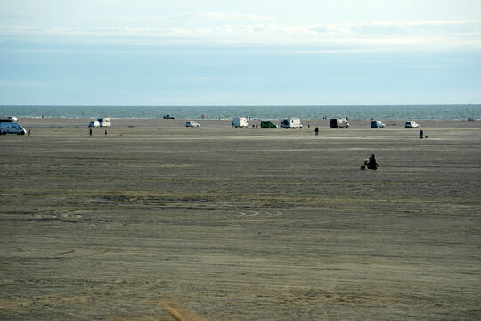 Vehicles and Motorcyclist on Wide Tidal Beach at Romo Denmark