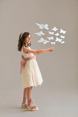 Girl releasing butterflies into magical world of imagination