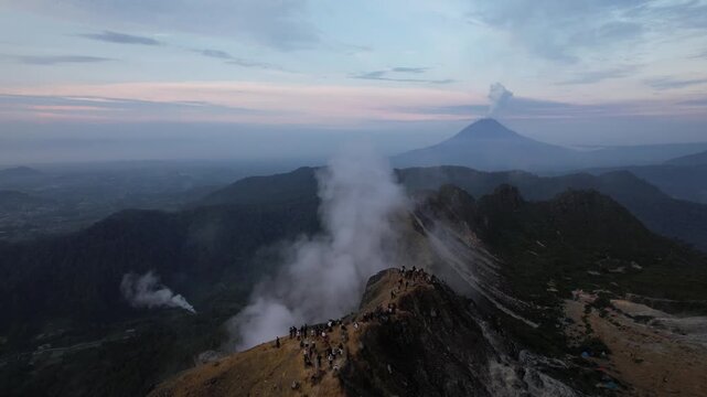 Drone video from the summit of an active volcano, Mount Sabayak with Mount Sinabung in the background, North Sumatra, Indonesia