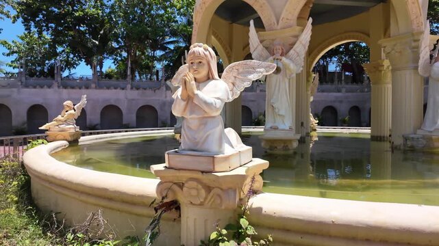 Praying angel statue on fountain at Simala Shrine in Cebu