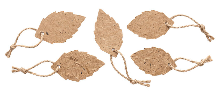 Kraft paper leaf price tags isolated on black background for eco friendly brand identity mockup. Blank kraft craft string label collection for organic product packaging and natural price tag copy spac