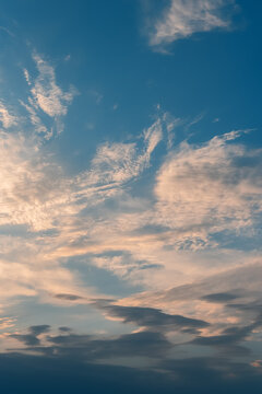 Beautiful blue sky with cirrus clouds at the beginning of sunset, vertical