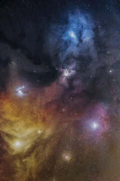 View of the colorful Rho Ophiuchi cloud complex featuring vibrant blue reflection nebulae, dark cosmic dust lanes, and glowing emission regions in the night sky of Poland.