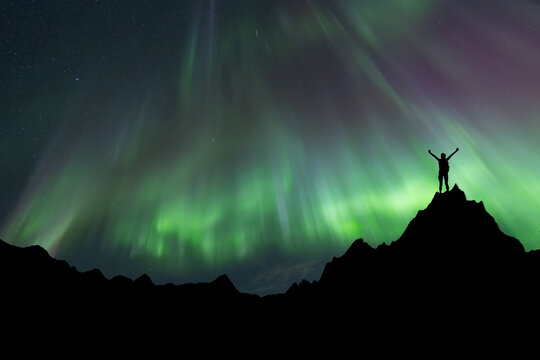 Silhouette of a team at the northen light background. Sport and active life concept and idea of team