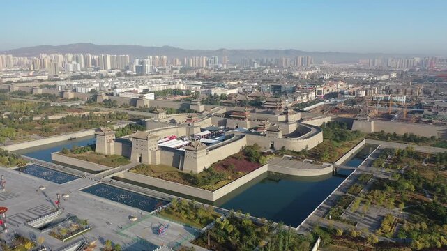 Aerial view of ancient city wall and moat in Xi'an, China, with modern skyline
