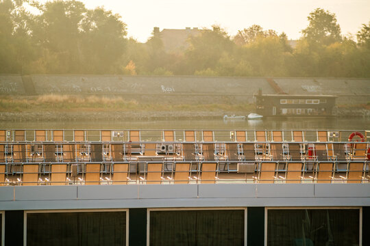 View of rows of sun loungers on the deck of a river cruise ship docked along the Danube river in Novi Sad, Vojvodina, Serbia.