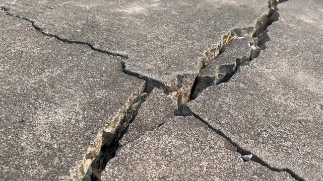 Deep crack on concrete surface earthquake damage and infrastructure failure concept