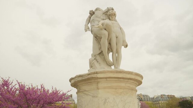 Classical Marble Sculpture in the Tuileries Garden with Spring Blossoms in Paris, France