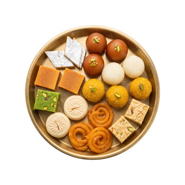 Variety of colorful indian sweets arranged on a plate isolated on transparent background
