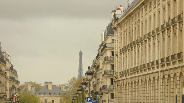 Eiffel Tower View Between Historic Parisian Buildings and Streets in Paris, France