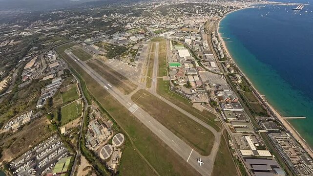 Aerial view of Cannes-Mandelieu Airport and surrounding French Riviera landscape, taken from plane