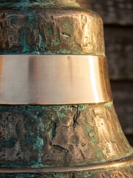 Macro Of Weathered Brass Bell With Green Patina And Blank Polished Band