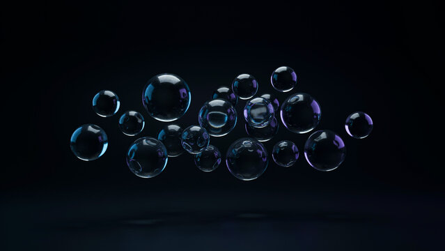A group of transparent soap bubbles floating over a dark surface texture