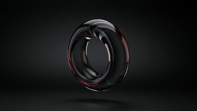 A single dark glass torus shape with red light reflections on a solid black background surface