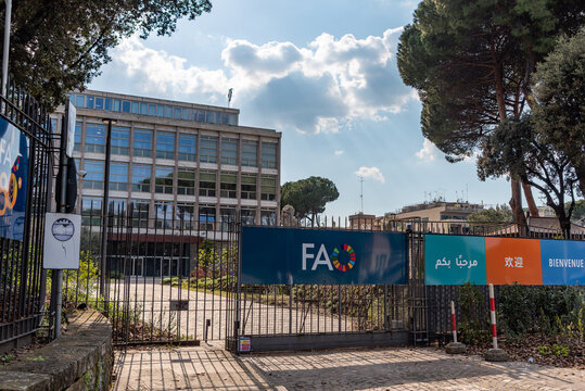 Rome, Italy - April 09, 2026 - Gate and Logo with FAO Headquarters Building in the Background, Rome