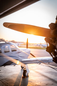 View of a Boeing Stearman biplane propeller and engine inside a hangar during golden hour at Langenhagen, Niedersachsen, Germany.